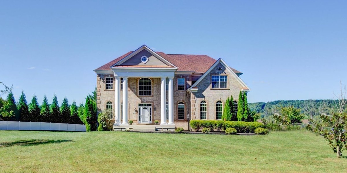 Grand brick building with tall columns and manicured landscaping
