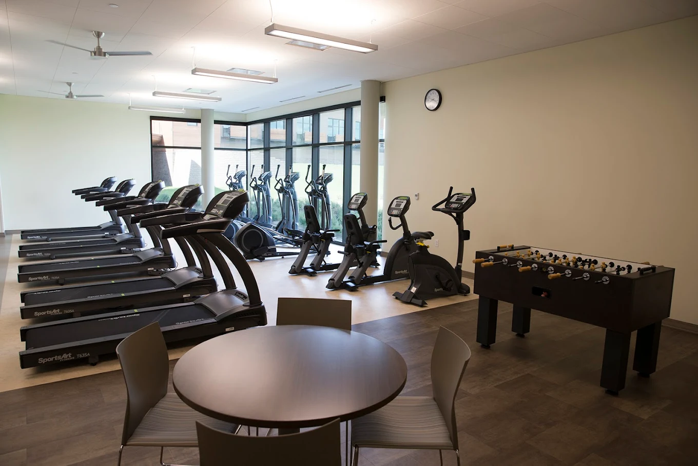 Gym with treadmills, bikes, and recreation area for patients
