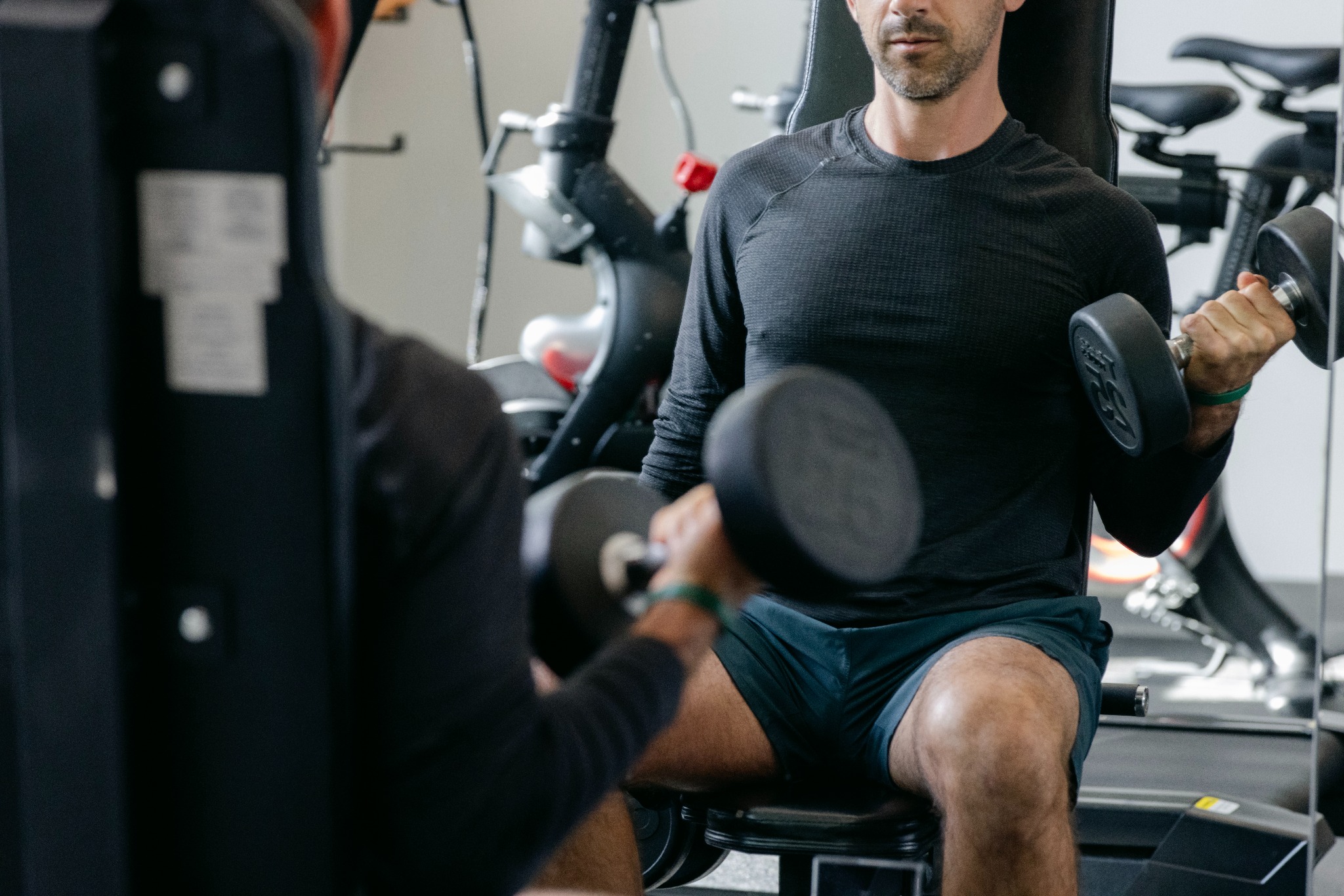 Man lifting dumbbells in rehab fitness center
