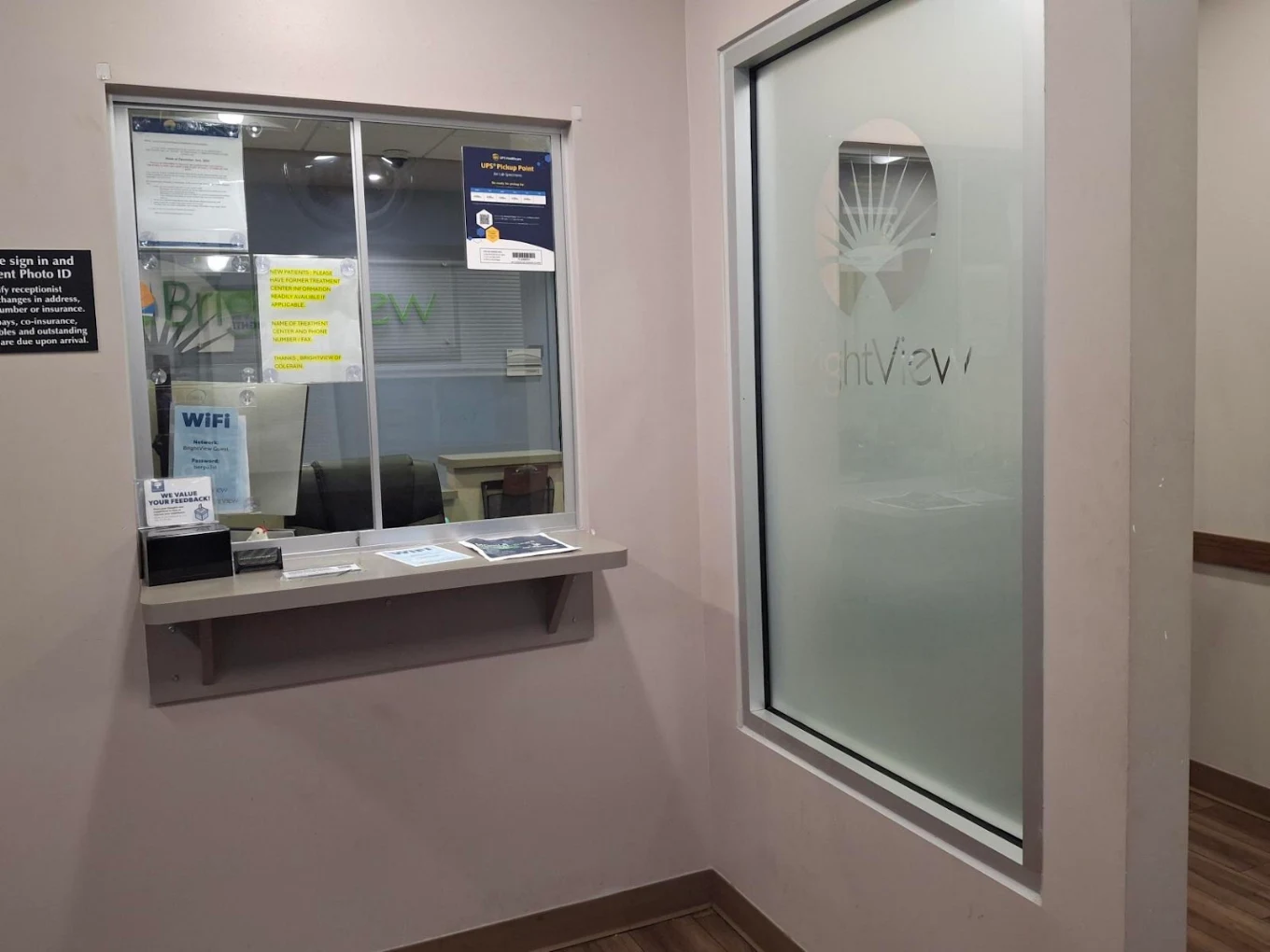 Patient check-in window beside frosted BrightView glass