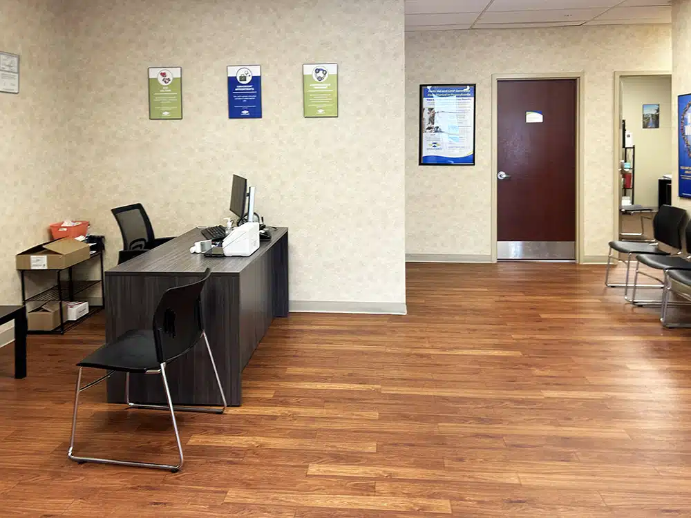 Reception desk with computer and seating at treatment center