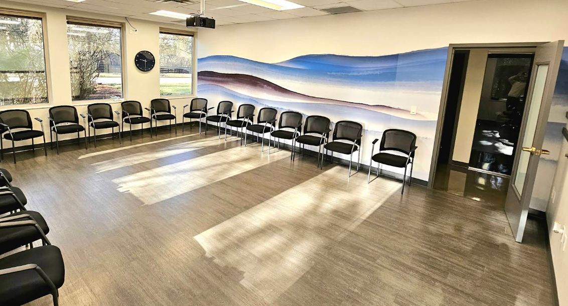 Bright group therapy room with chairs arranged in a circle