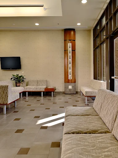 Comfortable waiting area with patterned seating and TV