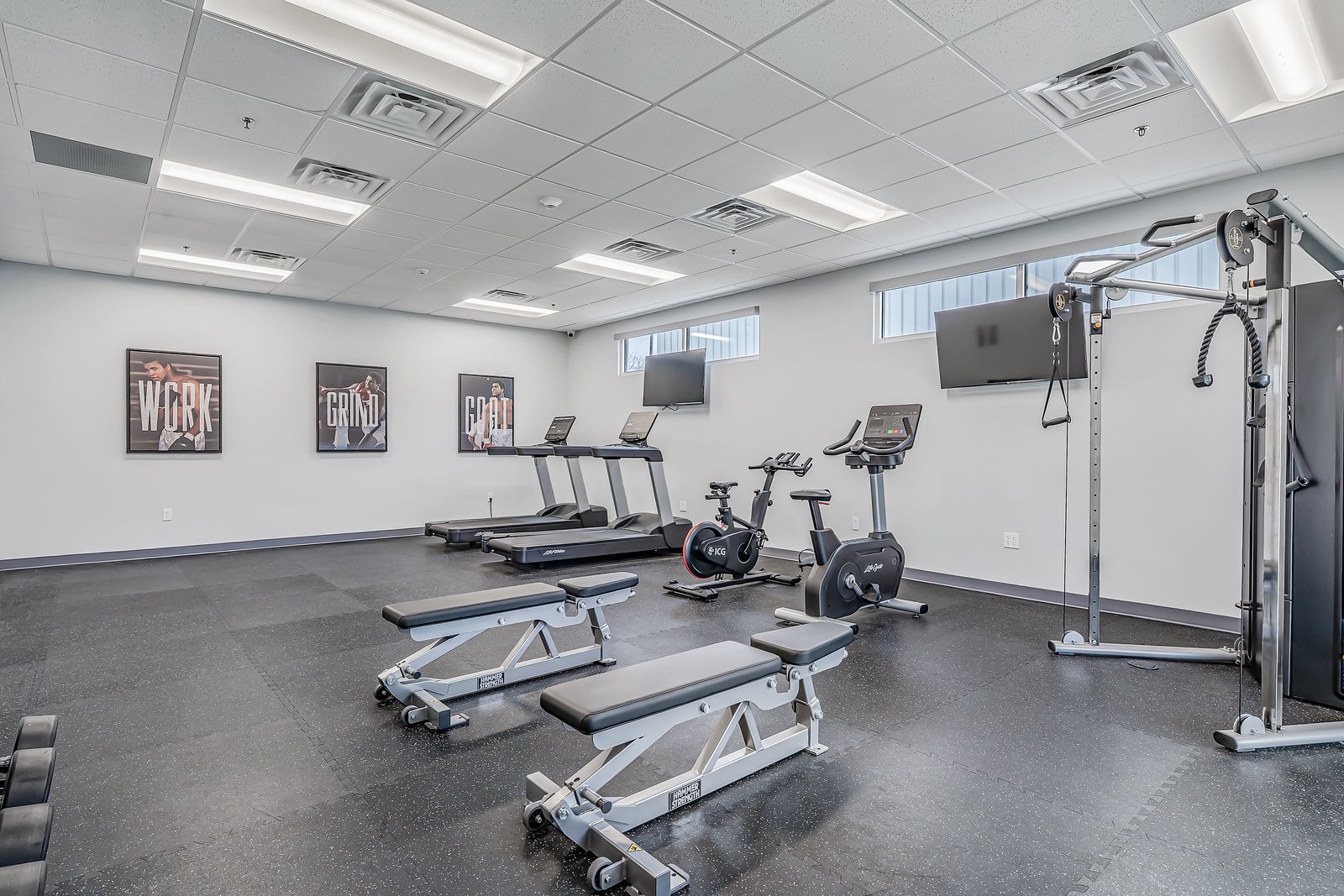 Gym with treadmills, bikes, and weight benches