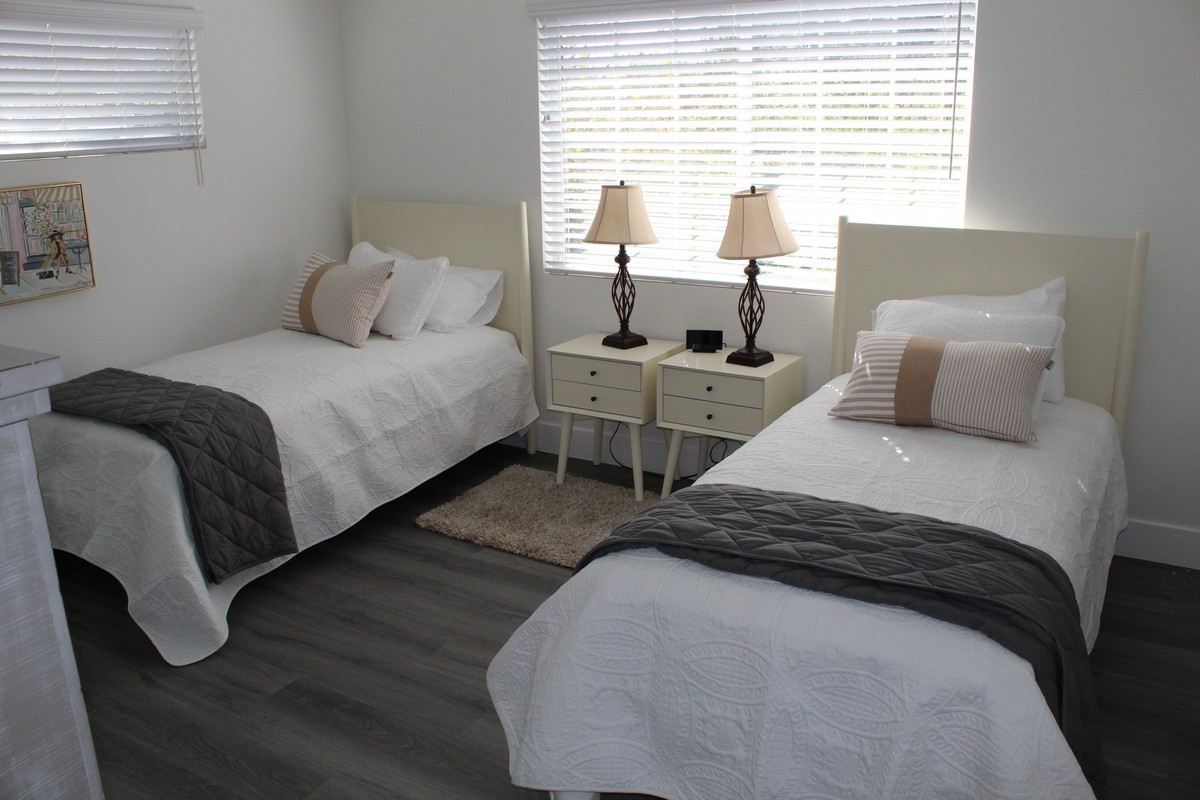 Shared bedroom with twin beds and natural light