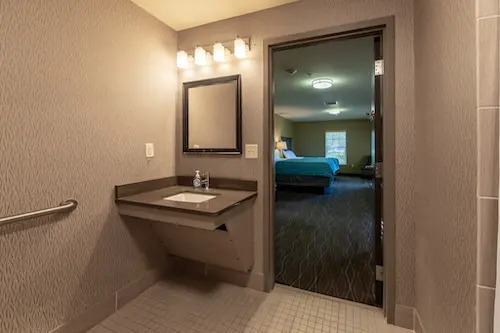 Bathroom with sink and view into bedroom