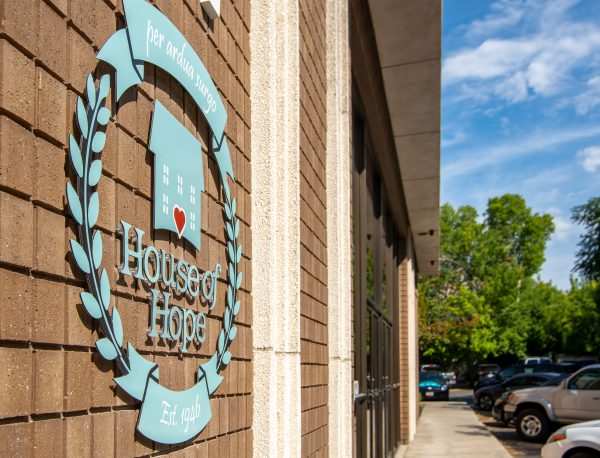 Logo with heart on building near parking area