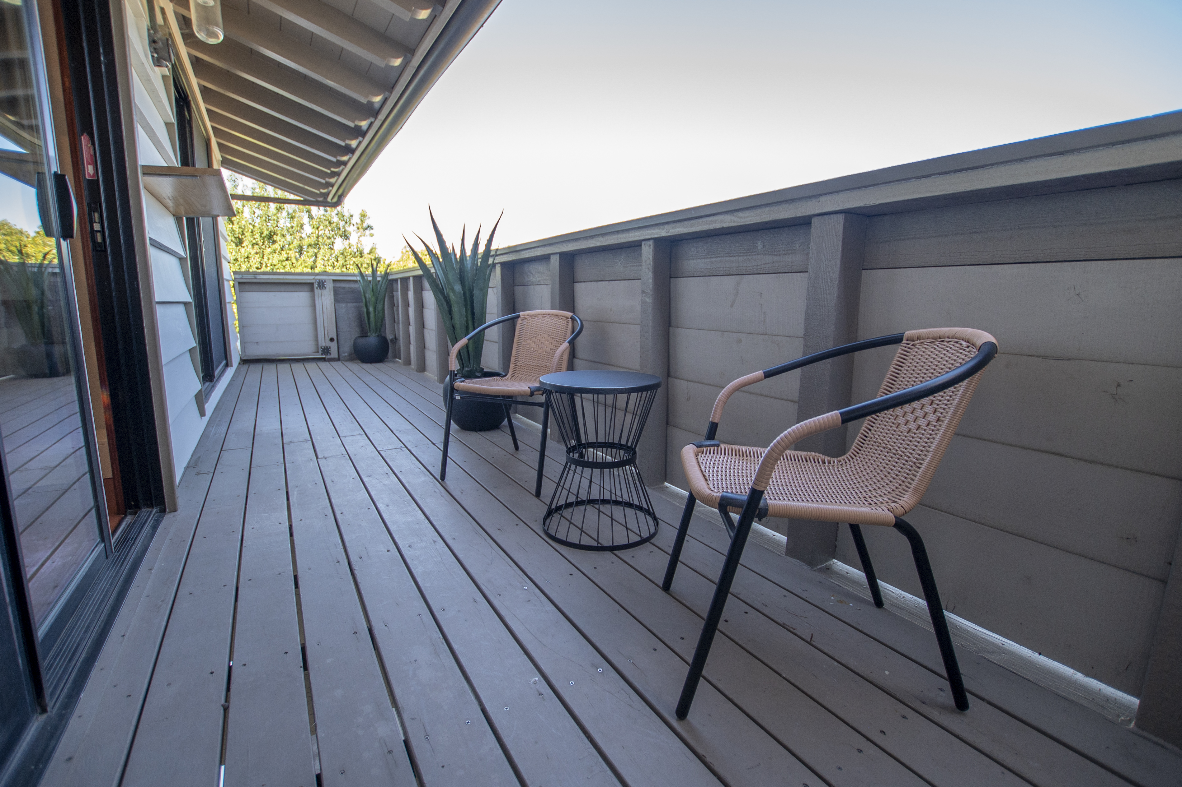 Small balcony with two chairs and a round table