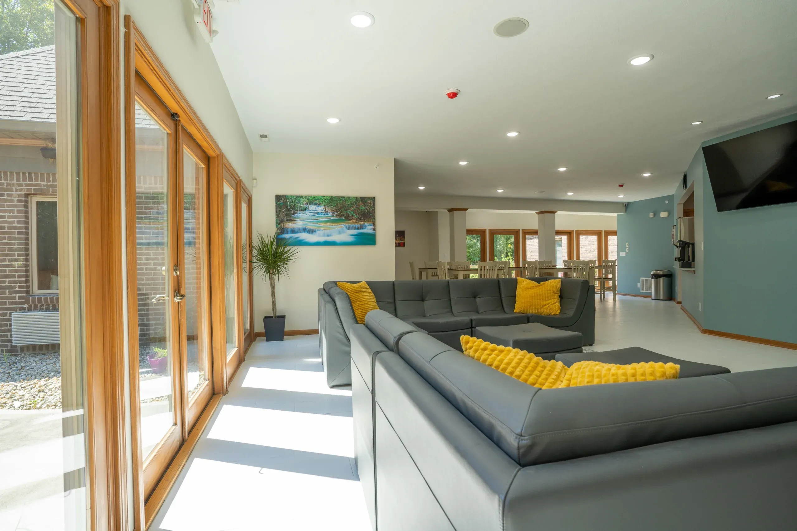 Bright lounge with gray sofas and large windows.