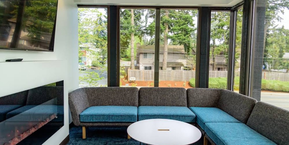 Comfortable lounge with sectional sofa and modern fireplace