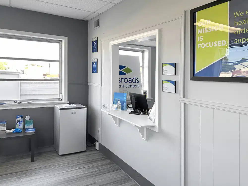 Reception window with desk and mini fridge at treatment center