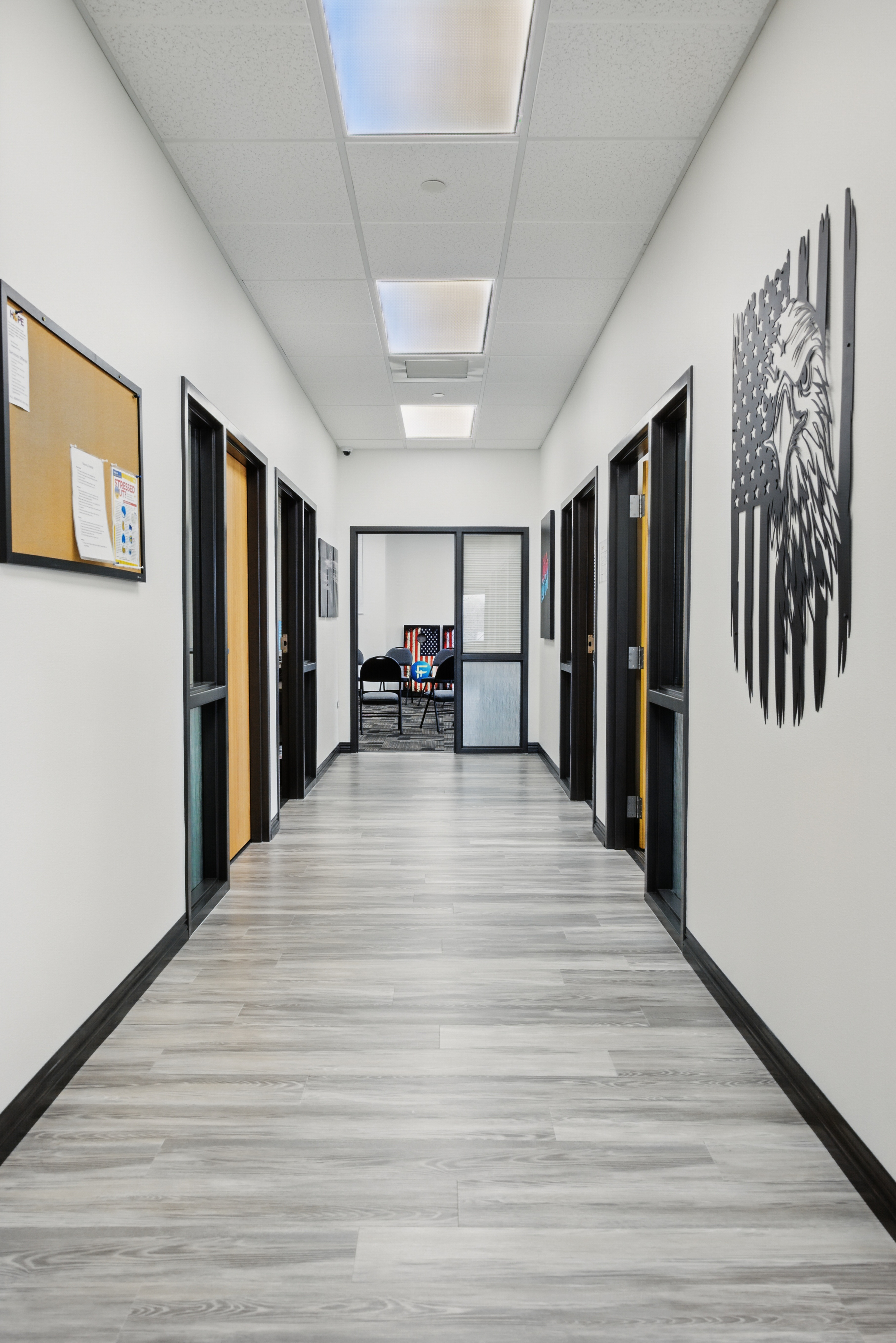 Clean hallway with office doors and eagle wall art