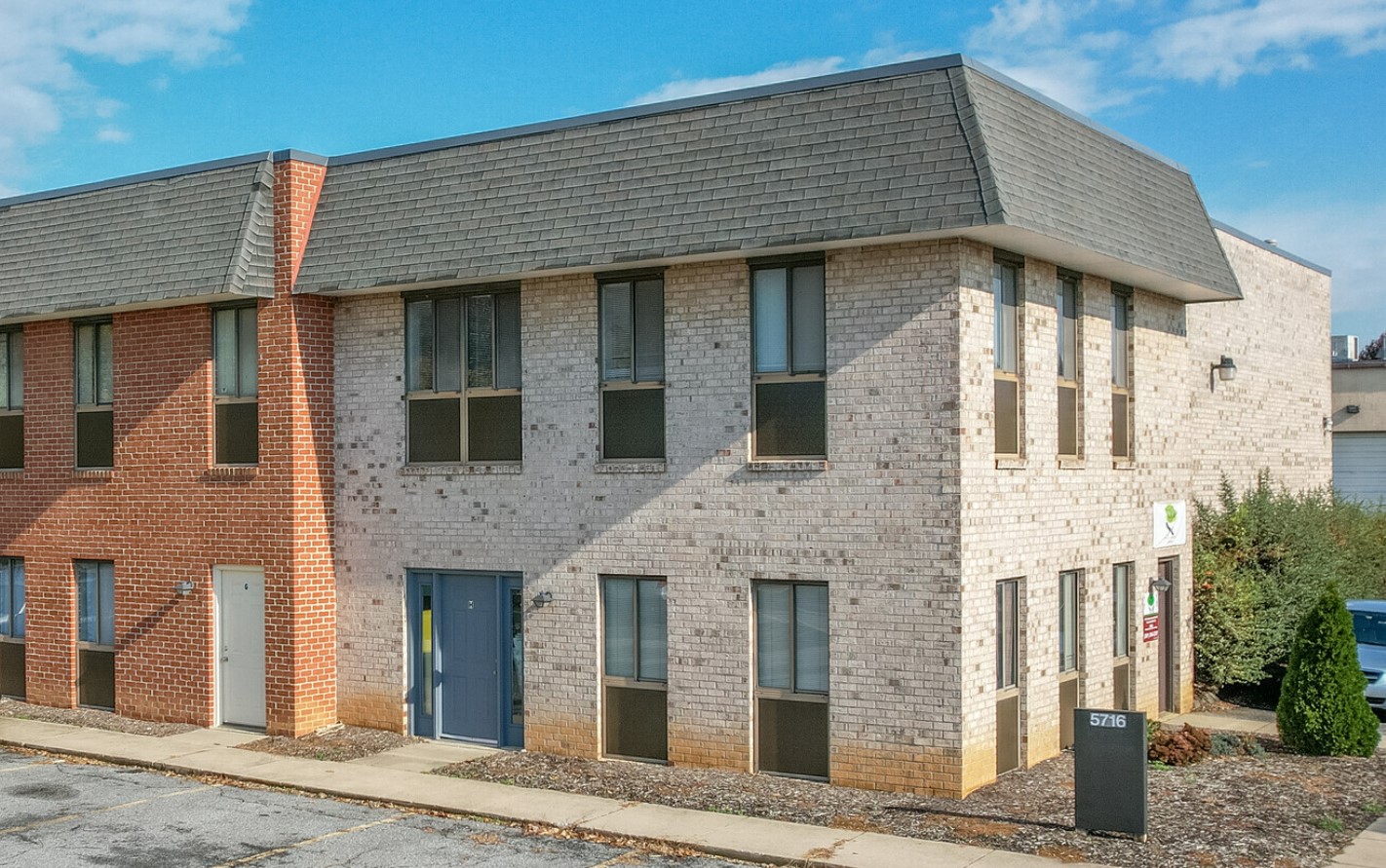 Front of Frederick Institute, showing a well-maintained two-story brick building with a distinct roofline.