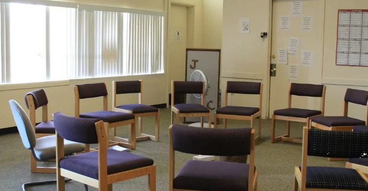 Circle of chairs in bright therapy meeting room