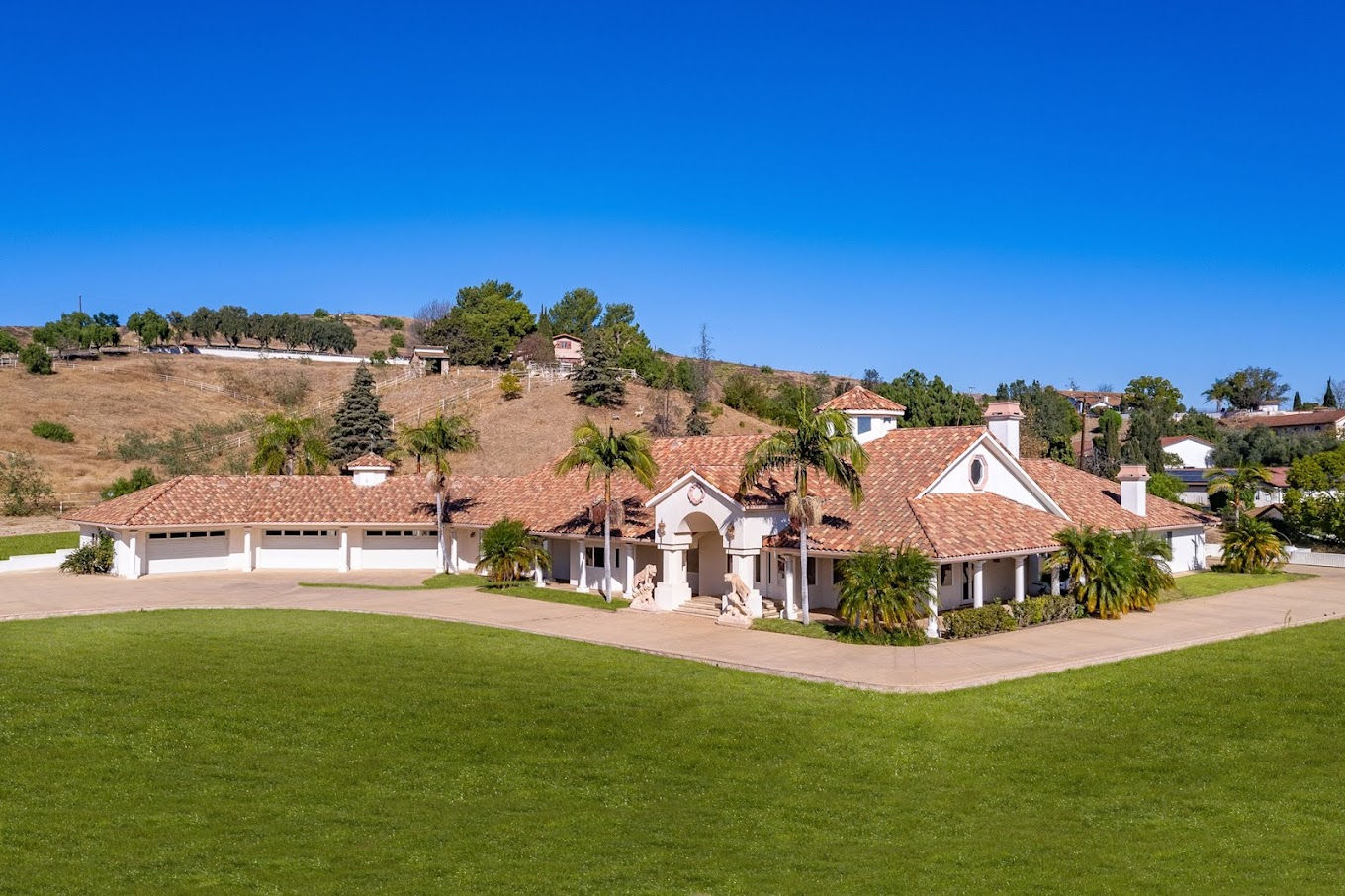 Large Spanish-style rehab facility with tiled roof and lawn