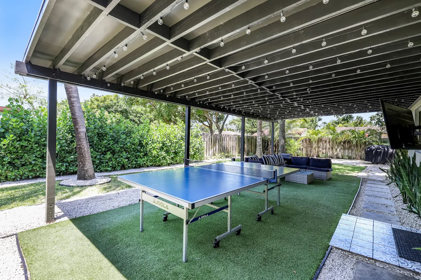 Covered patio with ping pong table and outdoor seating