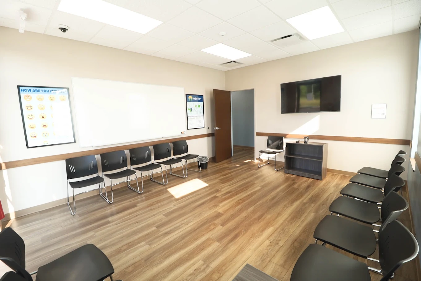 group therapy room with chairs and a tv.