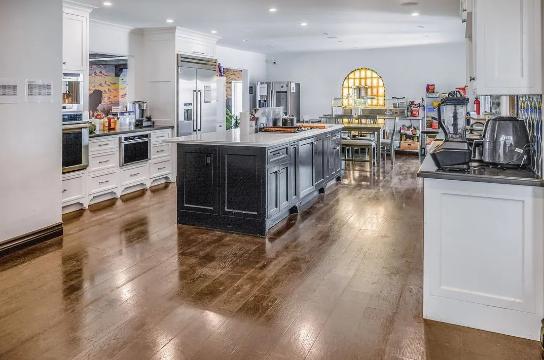Spacious gourmet kitchen with island and stainless steel appliances