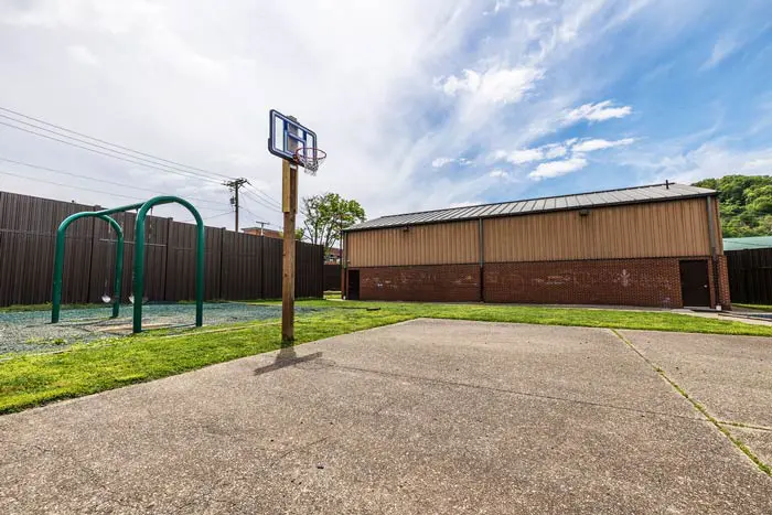Outdoor recreation area with basketball hoop and swings