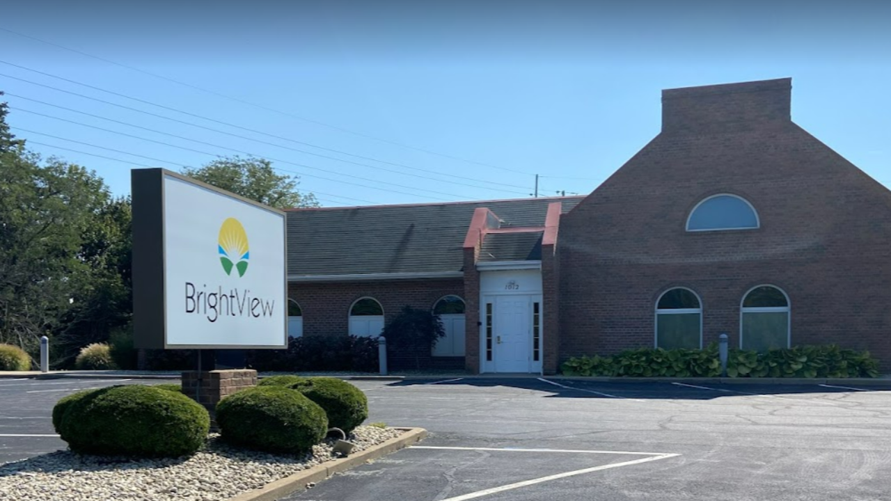 Exterior of BrightView Health Sandusky showing a brick building, large BrightView sign, landscaped shrubs, and parking lot