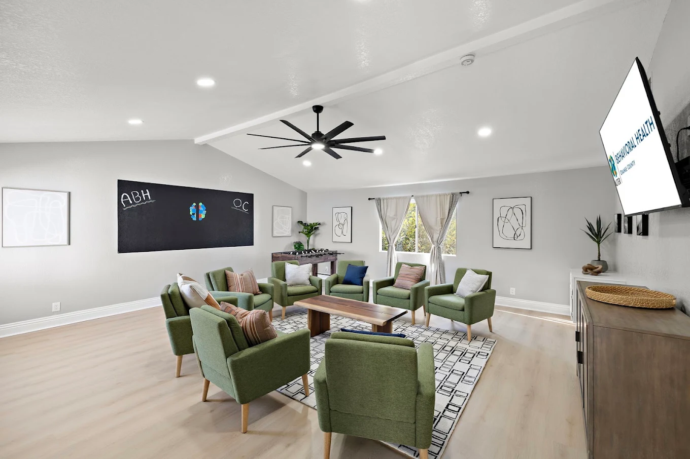 Group seating area with green chairs arranged around a table