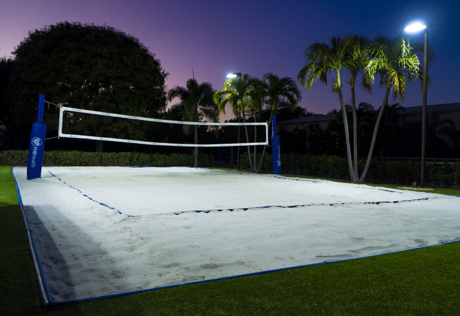 Outdoor sand volleyball court at night