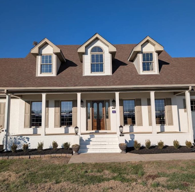Large rehab home exterior with covered front porch