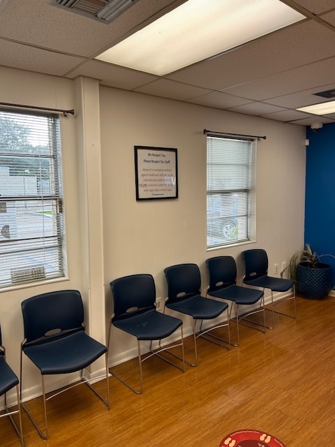 Lobby seating with blue chairs and large windows