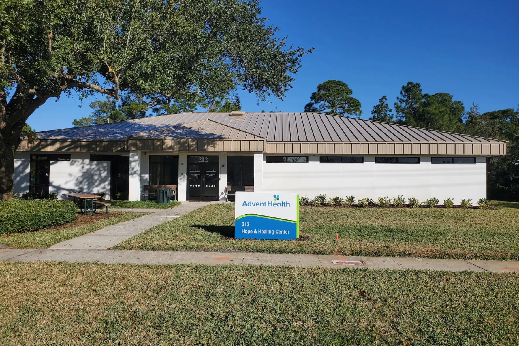 Facility exterior with lawn and AdventHealth sign