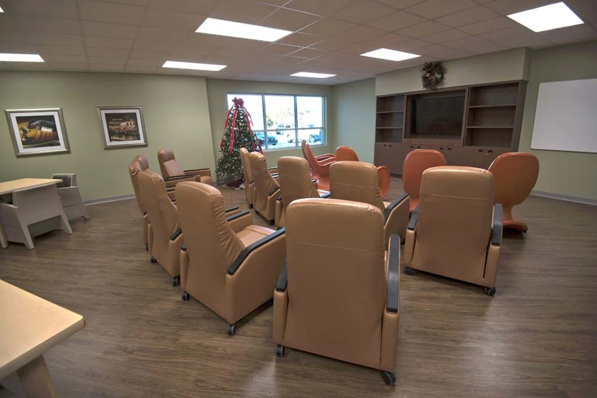 Group therapy room with recliners and presentation screen