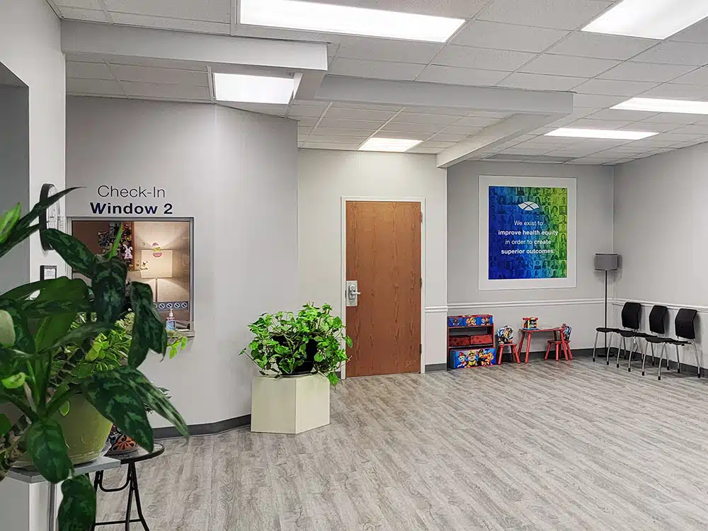 Reception area with check-in window, seating, and kids area