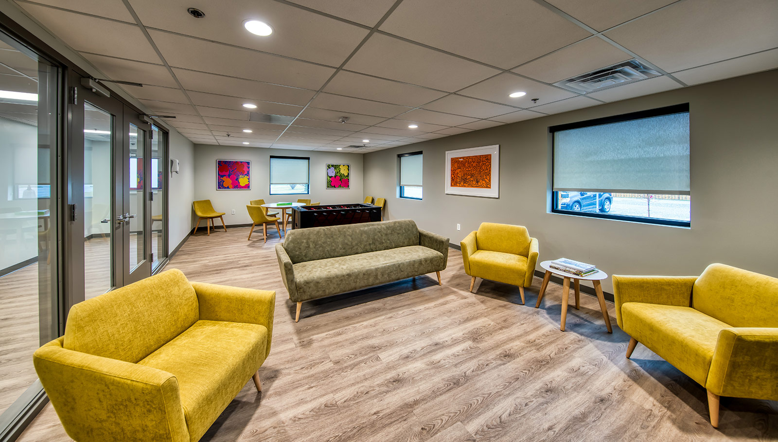 Room with football machine, colorful chairs, and art