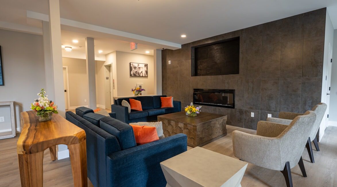 Modern common area with fireplace, comfortable seating, and social gathering space