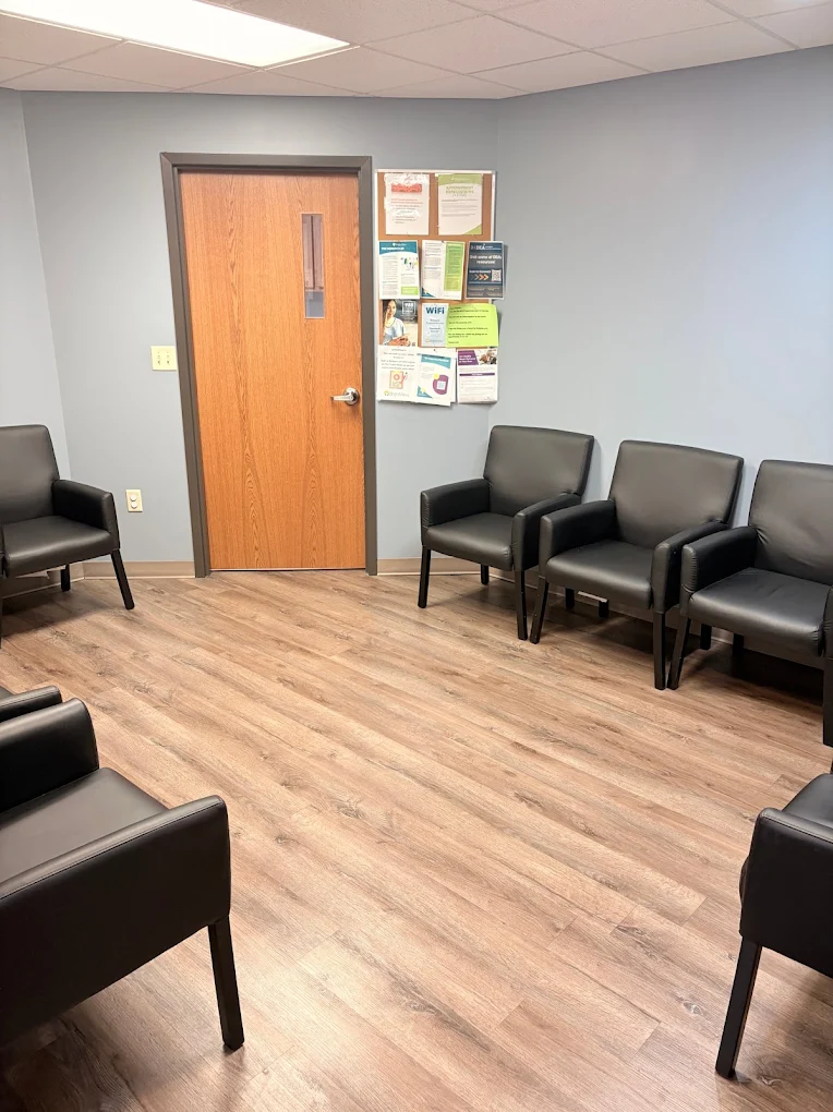 Waiting area with chairs and wood flooring