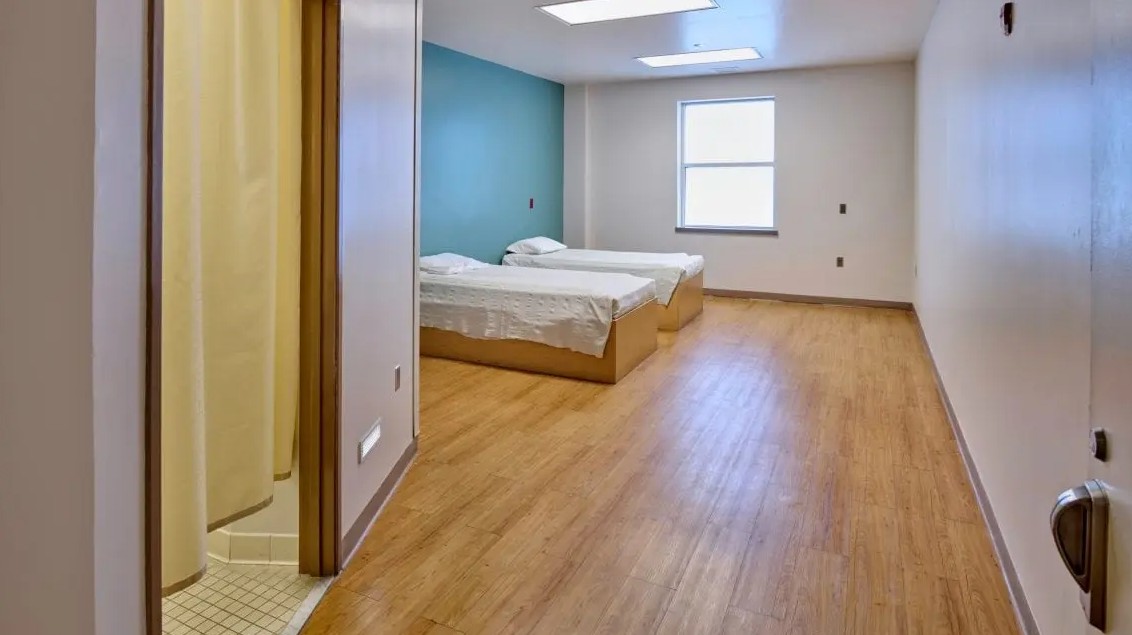 Shared patient room with two beds and bathroom