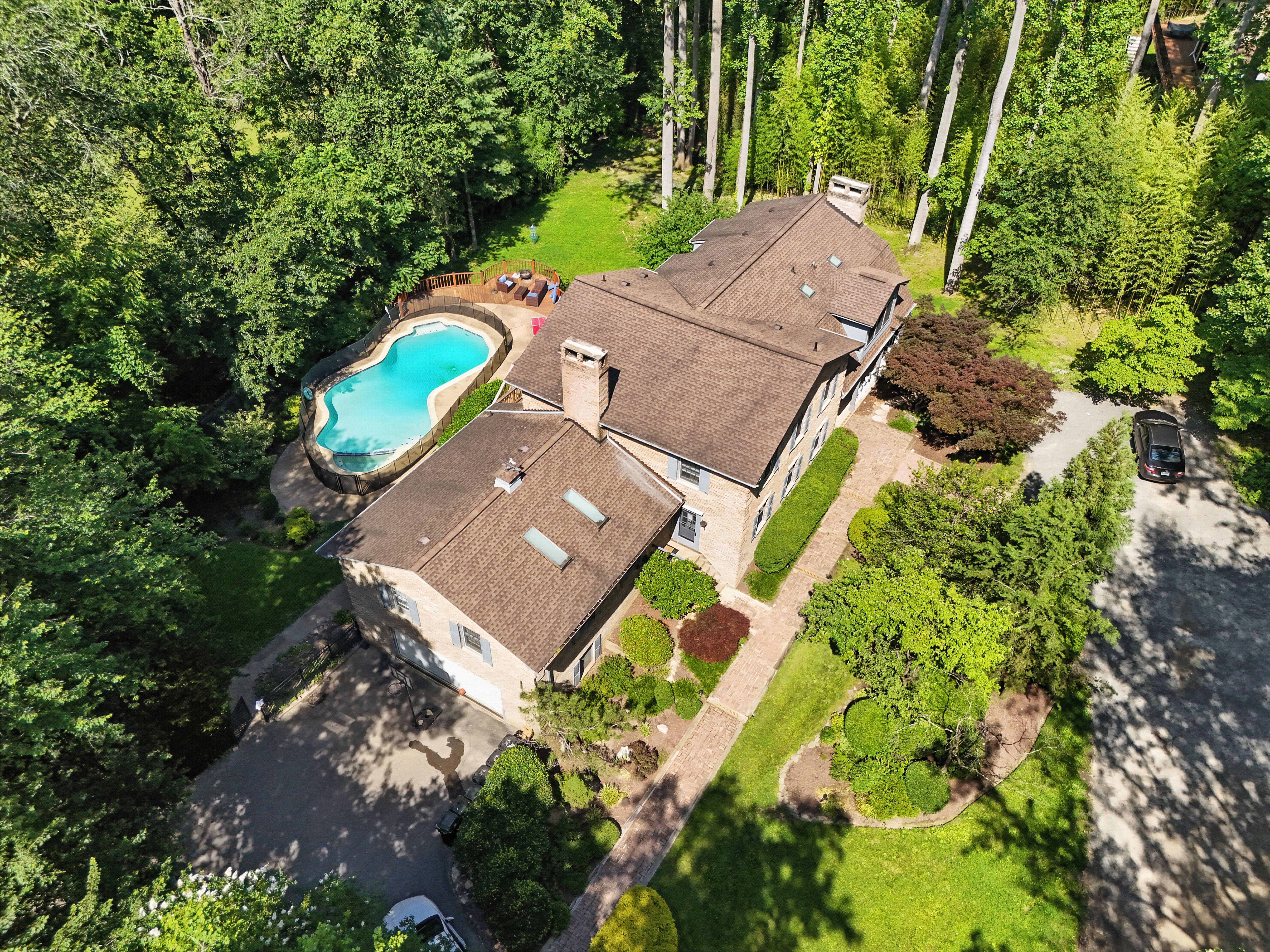 Aerial view of rehab facility with pool and wooded grounds