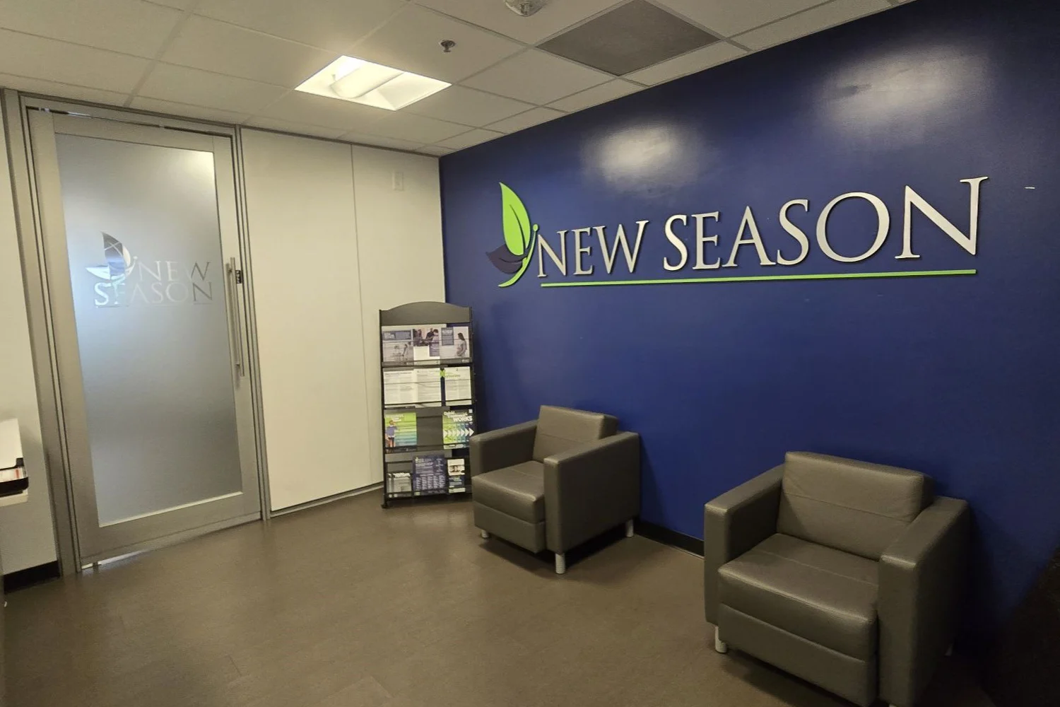 Lobby with two armchairs and New Season wall sign