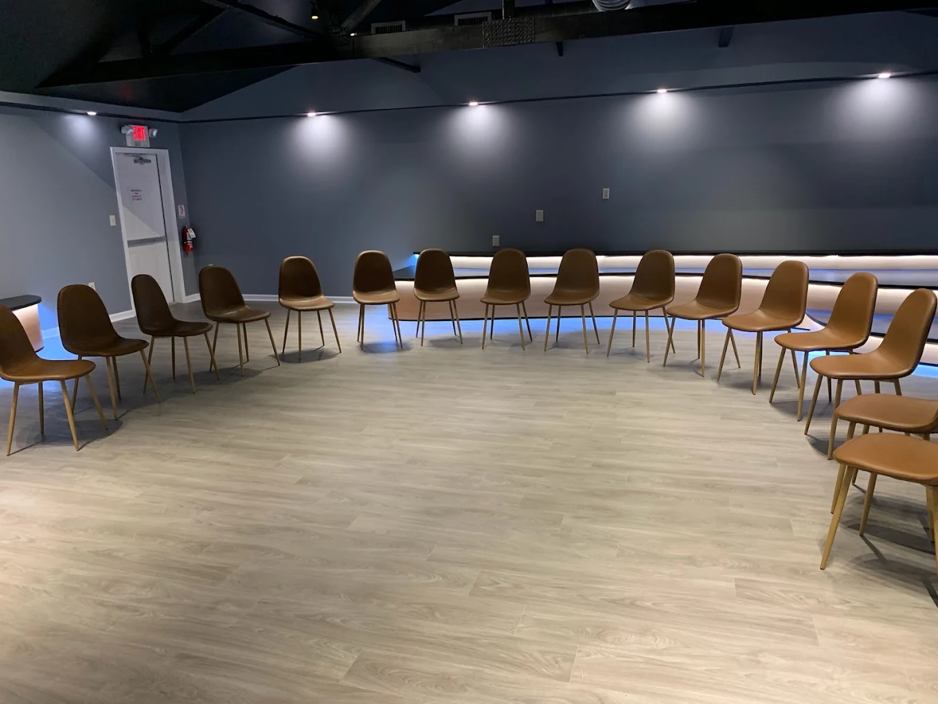 Circle of chairs in bright therapy meeting room