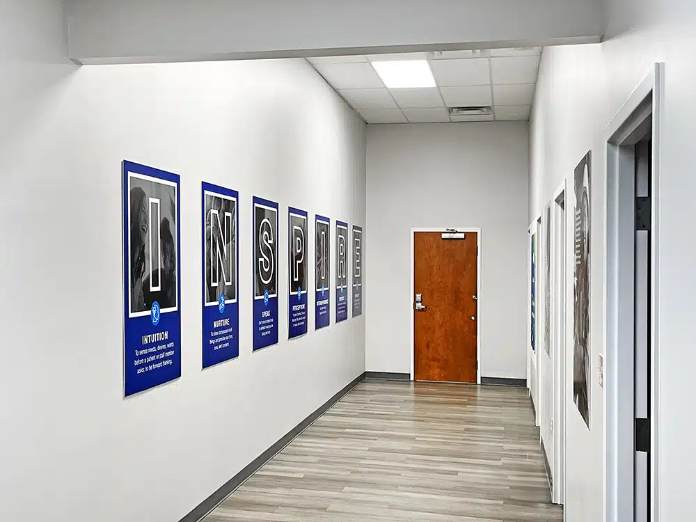 Hallway with Inspire posters and office doors