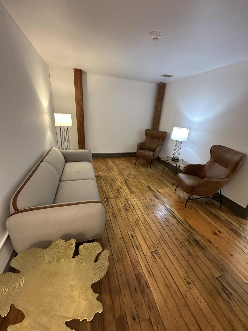 Private therapy room with a sofa and two armchairs