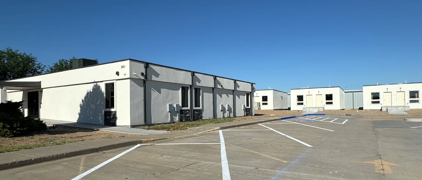 Exterior view of a rehabilitation facility building with parking area