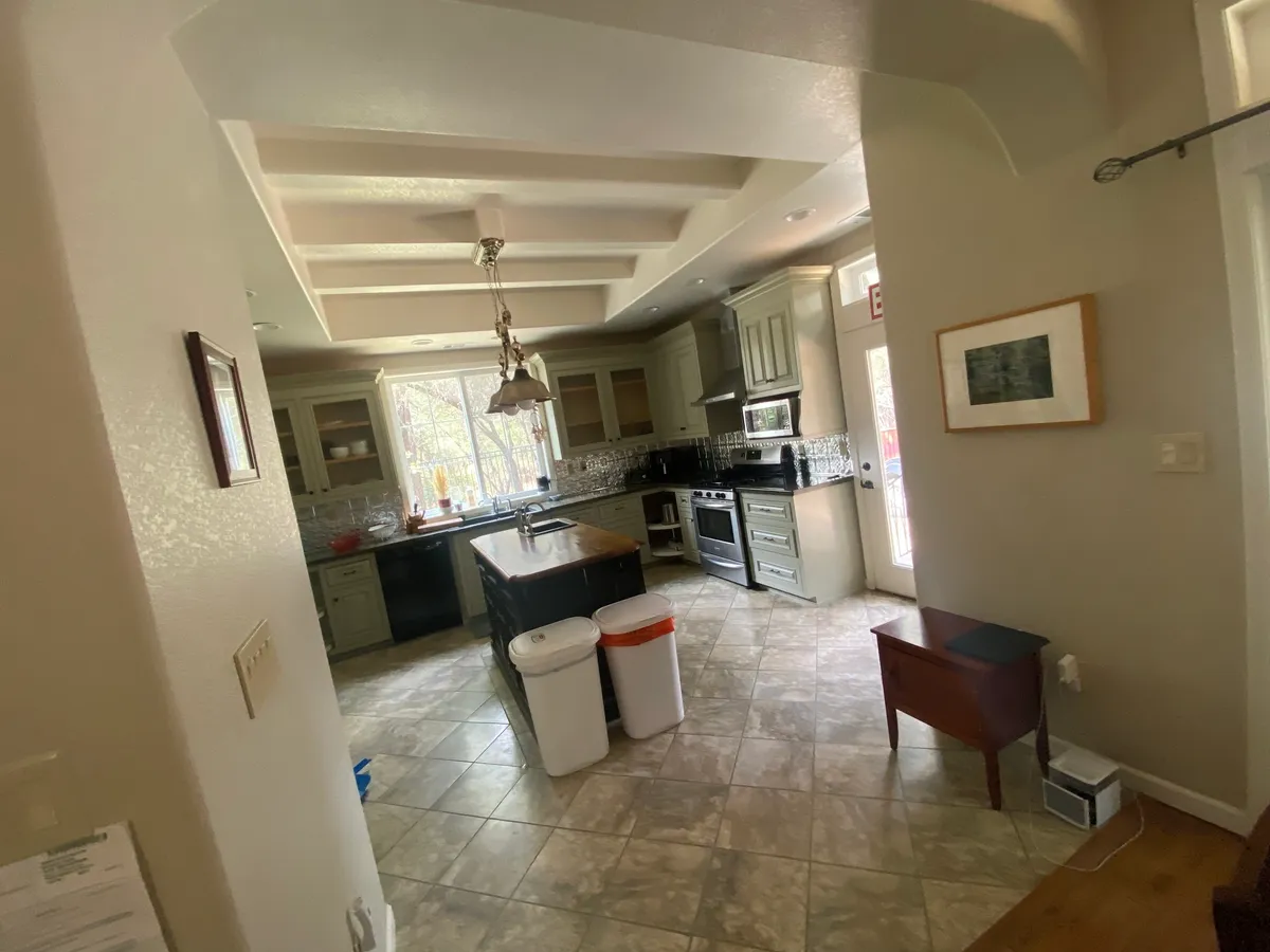 Spacious kitchen with island, cabinets, and natural light