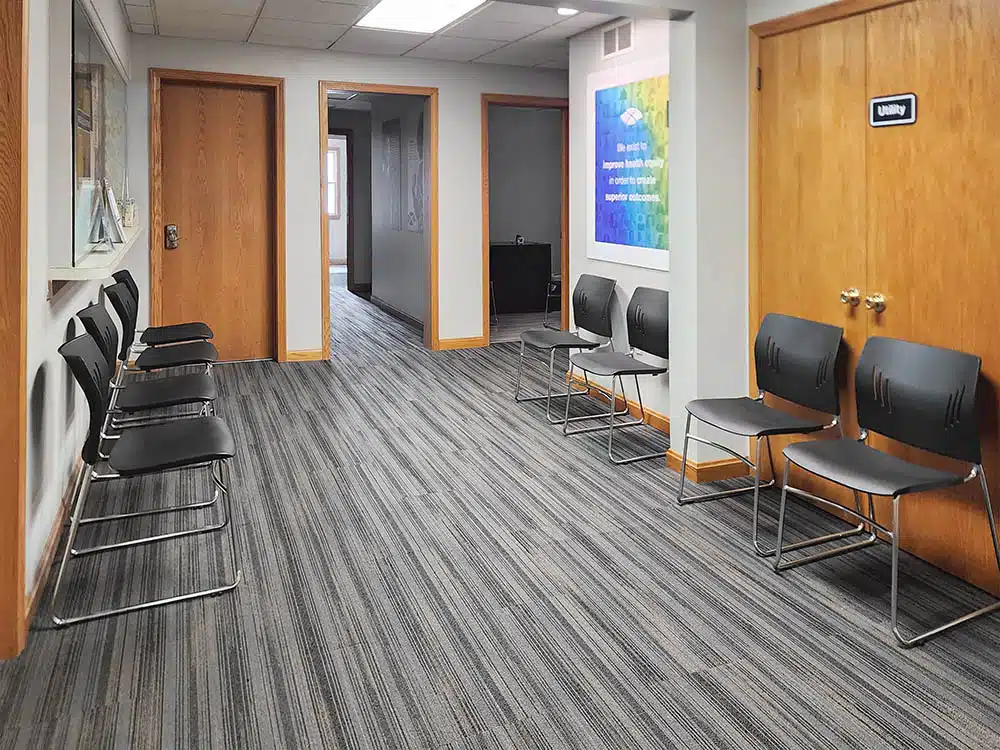 Hallway with multiple waiting chairs and office doors