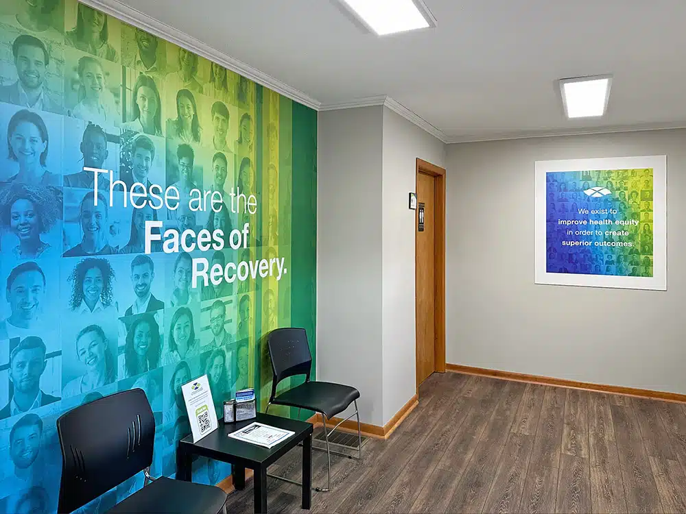Lobby seating with colorful Faces of Recovery wall mural