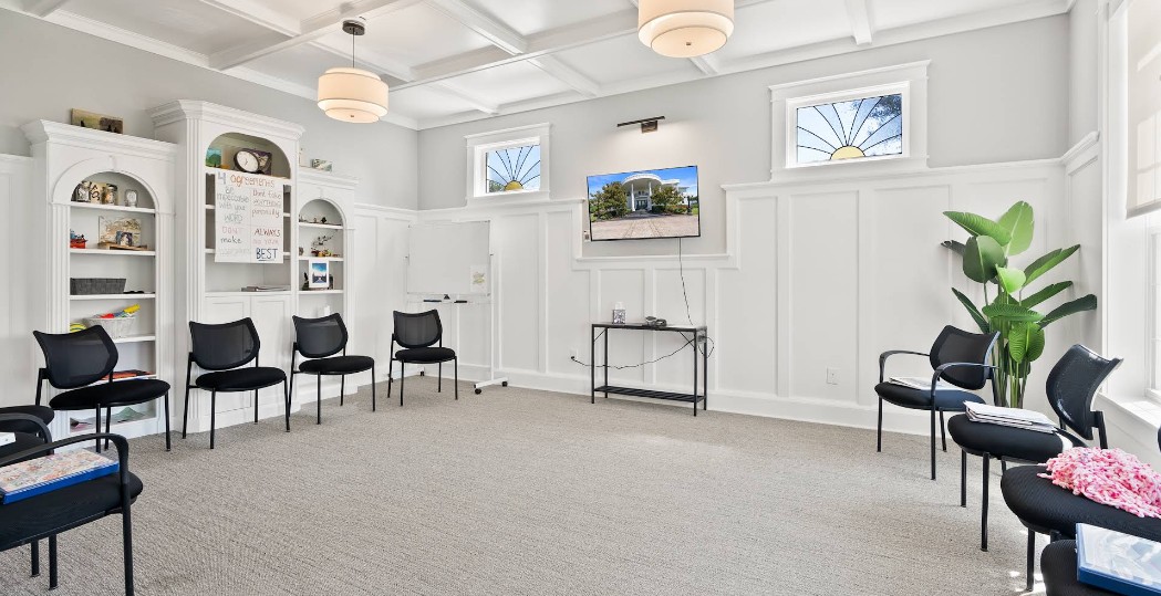 Group therapy room with chairs and TV