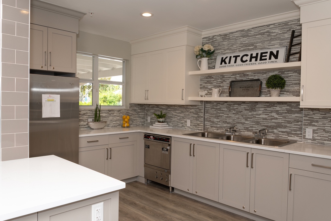 Modern kitchen with white cabinets and stainless appliances