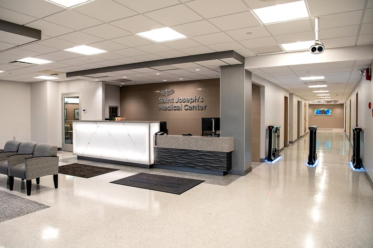 Reception lobby with front desk and hallway entrance.
