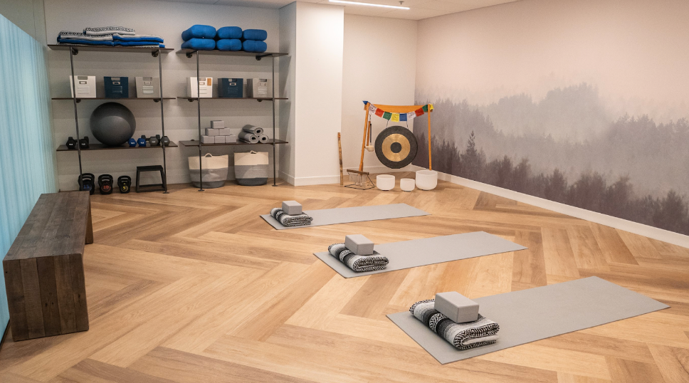 Wellness room with yoga mats, weights, and exercise equipment