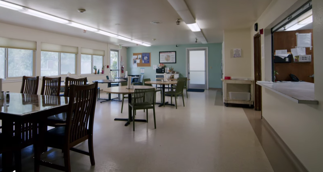 Bright dining room with tables, chairs, and natural light