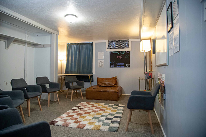 Meeting room with chairs along the walls and patterned rug